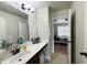Bathroom featuring a vanity with a sink, white counter and mirrors at 719 Lilac Mist Dr, Loganville, GA 30052