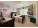 Bright bedroom with colorful decor, carpeted floor, and a window with blinds at 719 Lilac Mist Dr, Loganville, GA 30052