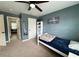 Bedroom featuring a white bed frame with a blue accent wall and carpeted floor at 719 Lilac Mist Dr, Loganville, GA 30052