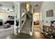Inviting entryway featuring staircase, hardwood floors, and views of living room and dining room at 719 Lilac Mist Dr, Loganville, GA 30052