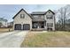 Stunning two-story brick home with a well-manicured lawn and attached two-car garage at 719 Lilac Mist Dr, Loganville, GA 30052