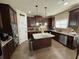 Well-lit kitchen showcasing stainless appliances, granite counters, and a kitchen island at 719 Lilac Mist Dr, Loganville, GA 30052