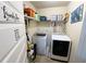 Efficient laundry room featuring a washer, dryer, and ample shelving for organized storage solutions at 719 Lilac Mist Dr, Loganville, GA 30052