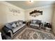 Cozy living room featuring comfortable seating, neutral decor, and a stylish area rug at 719 Lilac Mist Dr, Loganville, GA 30052