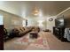 Inviting living room featuring a plush sofa, decorative rug, and modern lighting fixtures, perfect for relaxation at 719 Lilac Mist Dr, Loganville, GA 30052
