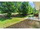 Lush backyard with mature trees, a patio, and an outdoor seating area perfect for relaxing at 1777 Cutters Mill Way, Lithonia, GA 30058