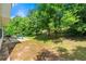 Expansive backyard with patio, seating, grill, and mature trees for shade and privacy at 1777 Cutters Mill Way, Lithonia, GA 30058