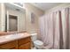 Bathroom features a vanity, toilet, shower with curtain, and neutral wall paint at 1777 Cutters Mill Way, Lithonia, GA 30058