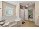 Bathroom features a bathtub, sink, and a view into the main bedroom at 1777 Cutters Mill Way, Lithonia, GA 30058