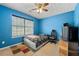 Bedroom showcasing a bed, window, colorful wall, and ceiling fan at 1777 Cutters Mill Way, Lithonia, GA 30058