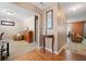 Inviting foyer with hardwood floors leading to carpeted living spaces, complemented by a decorative table and artwork at 1777 Cutters Mill Way, Lithonia, GA 30058