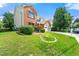 Well-manicured front yard with lush green grass, mature trees, and tidy landscaping surrounding a brick home at 1777 Cutters Mill Way, Lithonia, GA 30058
