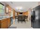 Open-concept kitchen with a stainless steel dishwasher and view of the adjacent dining area and living room, great for entertaining at 1777 Cutters Mill Way, Lithonia, GA 30058