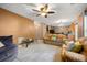 Bright living room featuring cozy furnishings, a ceiling fan, and an open connection to the kitchen at 1777 Cutters Mill Way, Lithonia, GA 30058