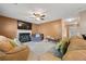 Comfortable living room with a fireplace, plush seating, a ceiling fan, and access to the entryway, ideal for relaxation at 1777 Cutters Mill Way, Lithonia, GA 30058