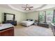 Spacious primary bedroom featuring a tray ceiling, comfortable bed, and sitting area at 1777 Cutters Mill Way, Lithonia, GA 30058