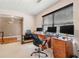 Home office featuring a large workspace with multiple monitors, a comfortable chair, and natural light, adjacent to hardwood floors at 1777 Cutters Mill Way, Lithonia, GA 30058