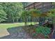 Backyard featuring a tiered deck and patio area, surrounded by mature trees and landscaping at 3491 Birchwood Trl, Snellville, GA 30078