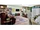 Cozy finished basement area with an entertainment center, kitchenette, recliner, and access to the backyard at 3491 Birchwood Trl, Snellville, GA 30078