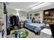 Small bedroom with light blue walls, clothing rack, shelving, and a cozy bed with plush pillows at 3491 Birchwood Trl, Snellville, GA 30078