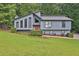 Charming home featuring a modern design, landscaped front yard, and a welcoming red front door at 3491 Birchwood Trl, Snellville, GA 30078