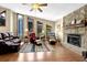 Inviting living room with a stone fireplace, hardwood floors, and abundant natural light at 3491 Birchwood Trl, Snellville, GA 30078