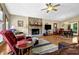 Cozy living room with fireplace, open to dining area, and filled with natural light at 3491 Birchwood Trl, Snellville, GA 30078