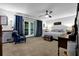 Bright main bedroom with ceiling fan, wood accents, french doors to deck, and elegant blue and white patterned bedding at 3491 Birchwood Trl, Snellville, GA 30078