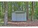 Outdoor storage shed in wooded backyard at 3491 Birchwood Trl, Snellville, GA 30078
