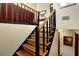 Elegant staircase with wooden steps and black railings leading to the upper level at 3491 Birchwood Trl, Snellville, GA 30078