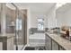 Well-lit bathroom featuring a shower, bathtub and granite countertops at 375 Auburn Valley Way, Auburn, GA 30011