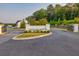 Community entrance sign surrounded by landscaping and black metal gates at 375 Auburn Valley Way, Auburn, GA 30011