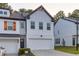 Charming two-story townhouse with white brick, a two-car garage, and contemporary design elements at 375 Auburn Valley Way, Auburn, GA 30011