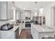 Modern kitchen featuring gray cabinets, granite countertops, stainless appliances, and island seating at 375 Auburn Valley Way, Auburn, GA 30011