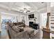 Spacious living room featuring a coffered ceiling, modern fireplace, and large sectional sofa at 375 Auburn Valley Way, Auburn, GA 30011