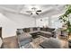 Bright living room with a large sectional sofa, coffered ceiling, and open layout at 375 Auburn Valley Way, Auburn, GA 30011