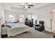 Spacious main bedroom with a bed, desk, and a sitting chair, offering a calm retreat at 375 Auburn Valley Way, Auburn, GA 30011