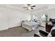 Airy bedroom features a bed, work area and a cozy chair at 375 Auburn Valley Way, Auburn, GA 30011