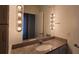 Bathroom featuring vanity lights and granite countertop, with a contemporary design and modern fixtures at 620 Glen Iris Ne Dr # 321, Atlanta, GA 30308