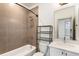 Modern bathroom with tiled shower, vanity with white countertop, and sleek fixtures at 92 Rogers Ne St, Atlanta, GA 30317