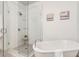 Bathroom featuring a shower, free standing tub and neutral color palette at 92 Rogers Ne St, Atlanta, GA 30317
