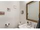 Stylish half bathroom with a modern sink, framed mirror, and decorative wall art at 92 Rogers Ne St, Atlanta, GA 30317