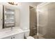 Bathroom with glass shower, white vanity, and tile walls providing a clean modern feel at 92 Rogers Ne St, Atlanta, GA 30317