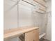 Custom closet with wooden drawers, shelving, and ample hanging space to organize clothing and accessories at 92 Rogers Ne St, Atlanta, GA 30317