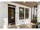 Exterior of white brick townhouse featuring front door with glass panes, and manicured landscaping at 92 Rogers Ne St, Atlanta, GA 30317