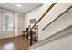 Bright foyer featuring hardwood floors, staircase with wire railing, and modern decor elements at 92 Rogers Ne St, Atlanta, GA 30317