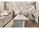 Gourmet kitchen with stainless appliances, island with bar seating, and modern pendant lighting at 92 Rogers Ne St, Atlanta, GA 30317