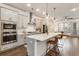 Bright kitchen with stainless steel appliances, a large island with bar seating, and pendant lighting at 92 Rogers Ne St, Atlanta, GA 30317