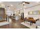 Open concept living room features wood floors, stairs, kitchen with bar seating and contemporary furnishings at 92 Rogers Ne St, Atlanta, GA 30317