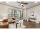Bright living room with a ceiling fan, wooden floors, large windows and sliding doors leading to a balcony at 92 Rogers Ne St, Atlanta, GA 30317